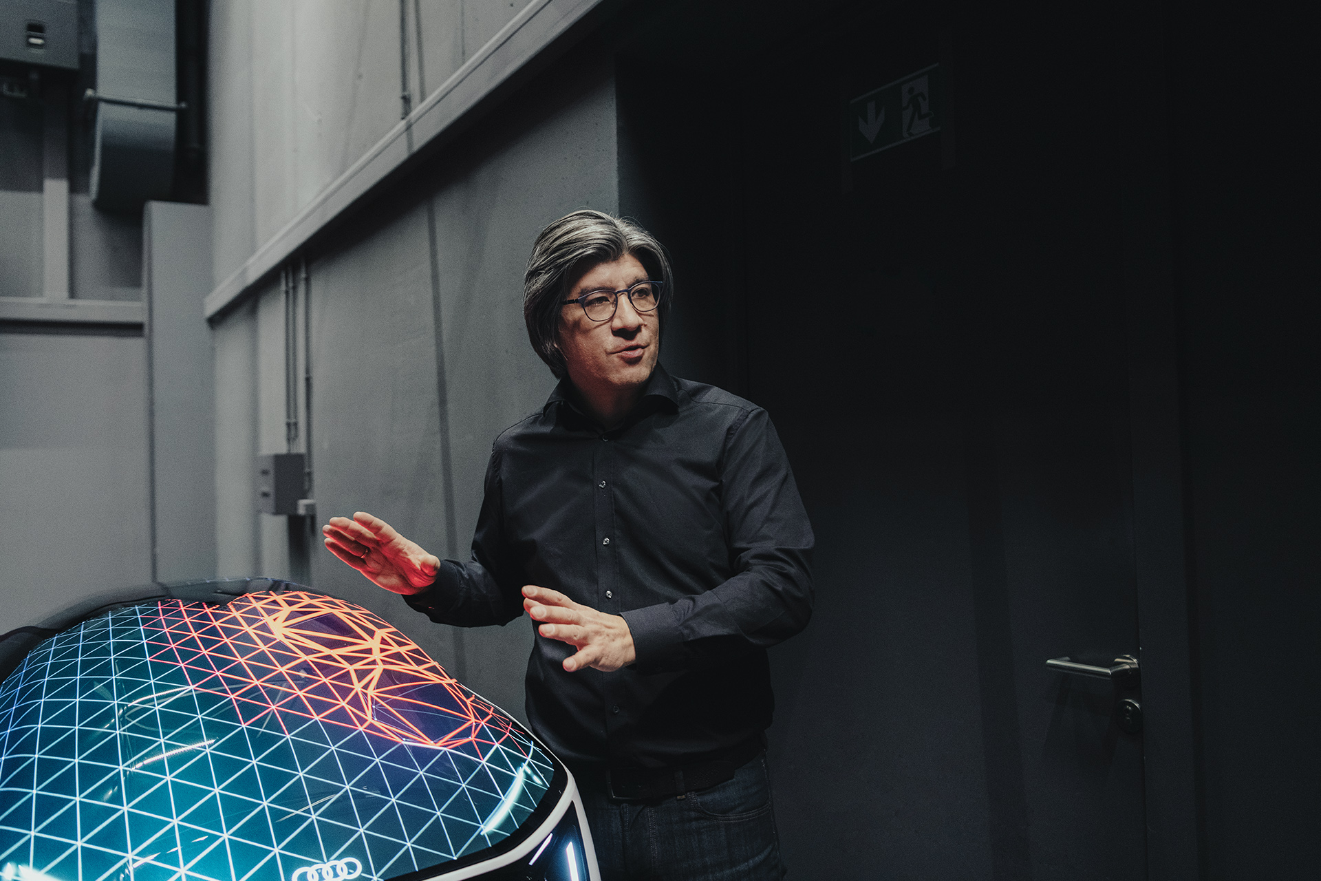 Stephan Berlitz runs his hands over an Audi light model.